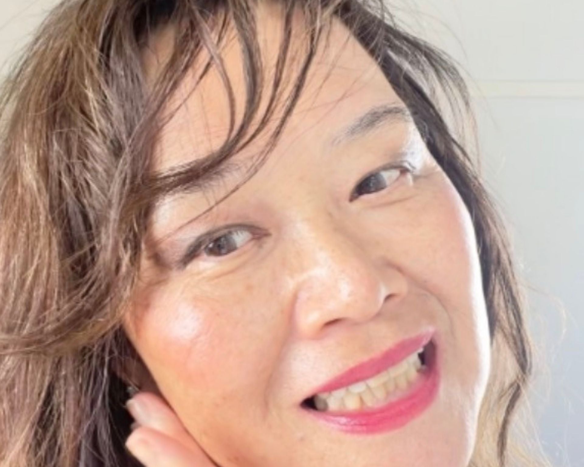 Founder (71 years old)  of LA MAXIME with radiant glowing skin demonstrating results for mature skin skincare