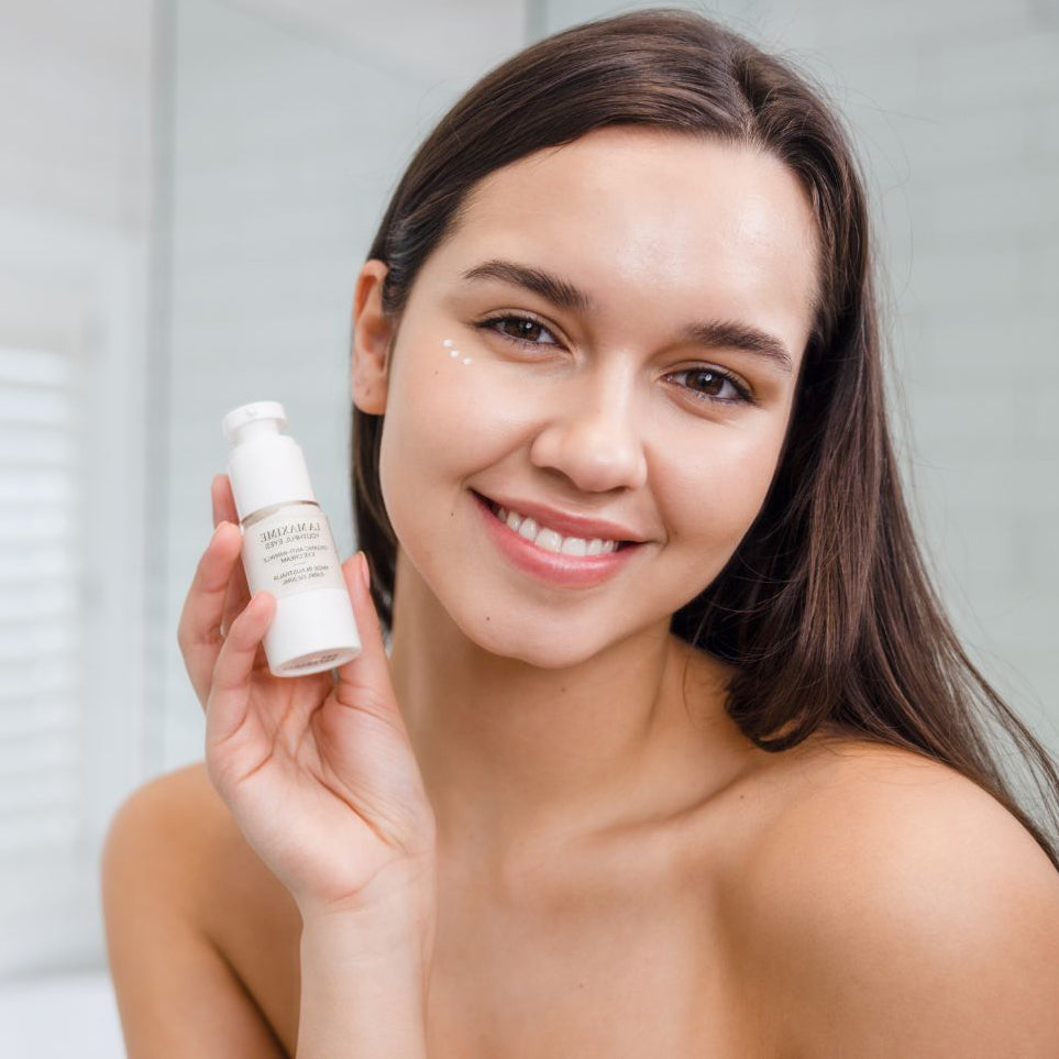 woman holding LA MAXIME Youthful Eyes organic anti-wrinkle eye cream