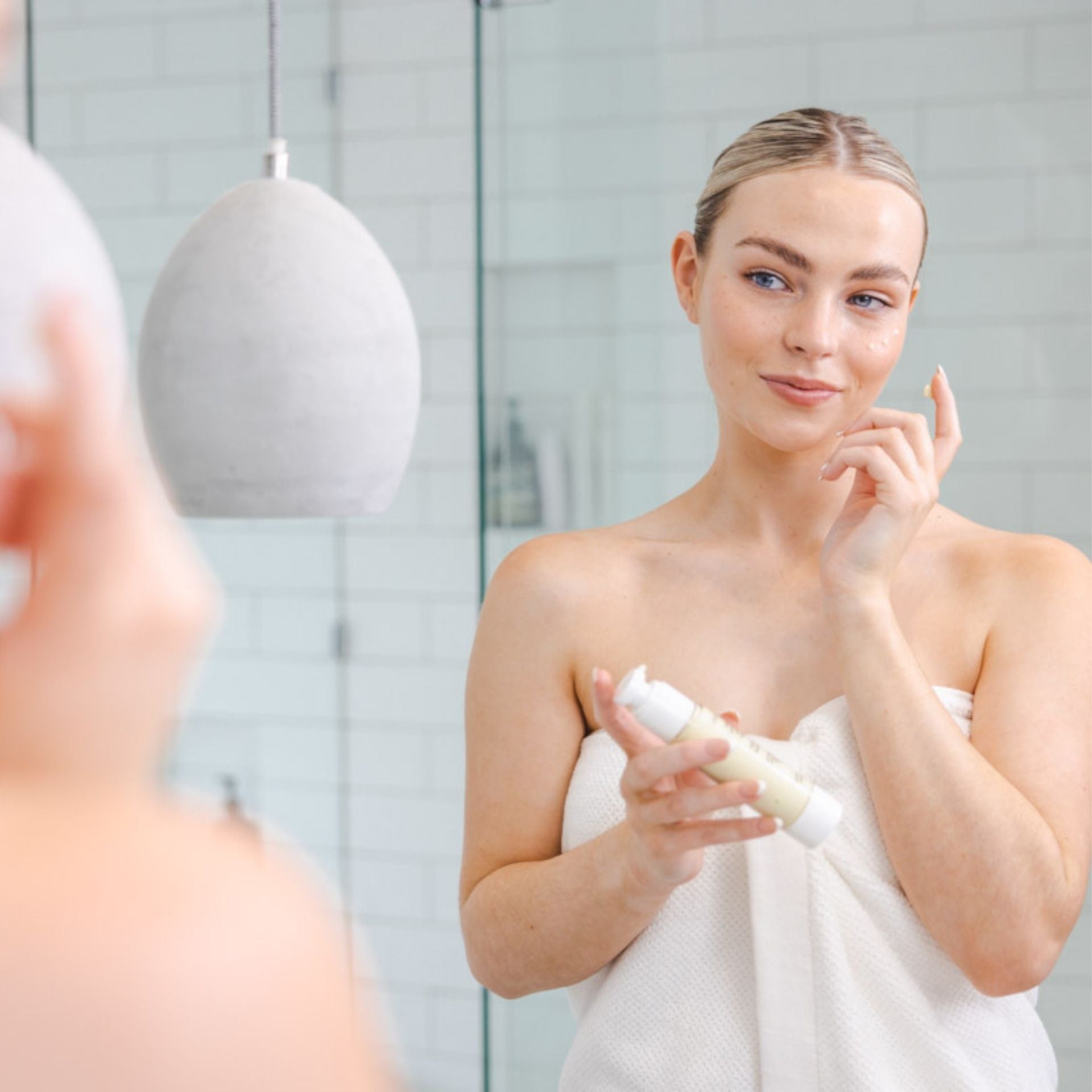 Applying antioxidant night cream as part of evening skincare routine for hydration and skin repair
