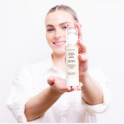 Woman holding LA MAXIME night cream showing visible results for smoother firmer skin