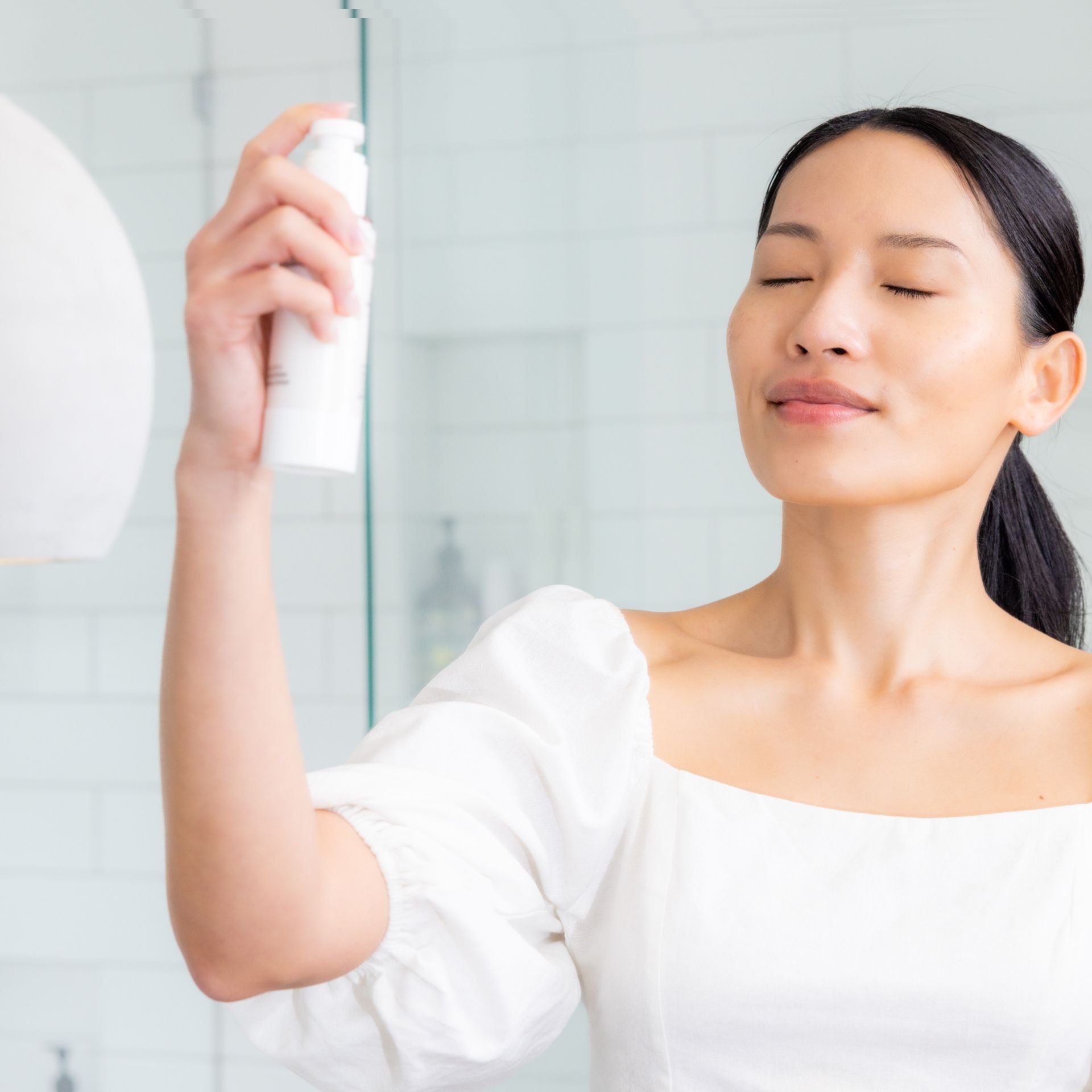 Applying toning milk mist to hydrate and refresh skin for a radiant healthy glow