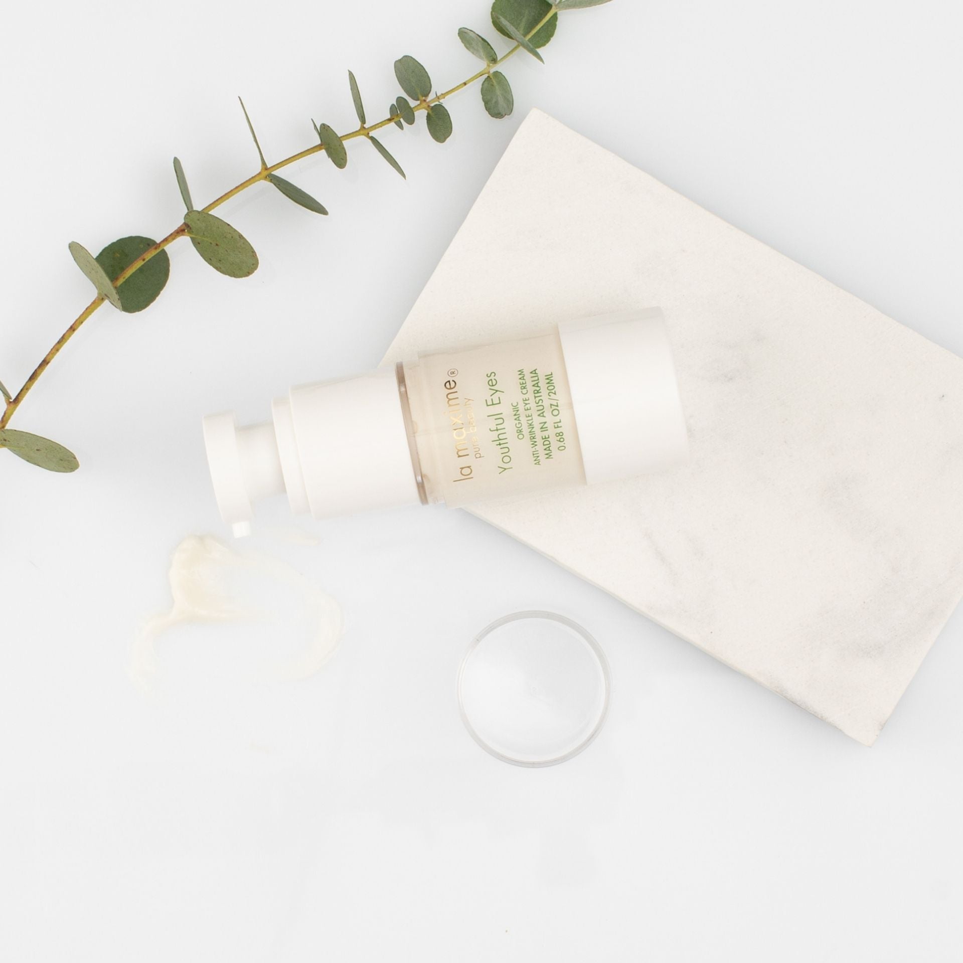 Organic eye cream with natural botanical ingredients styled on minimal background for sensitive and mature skin care